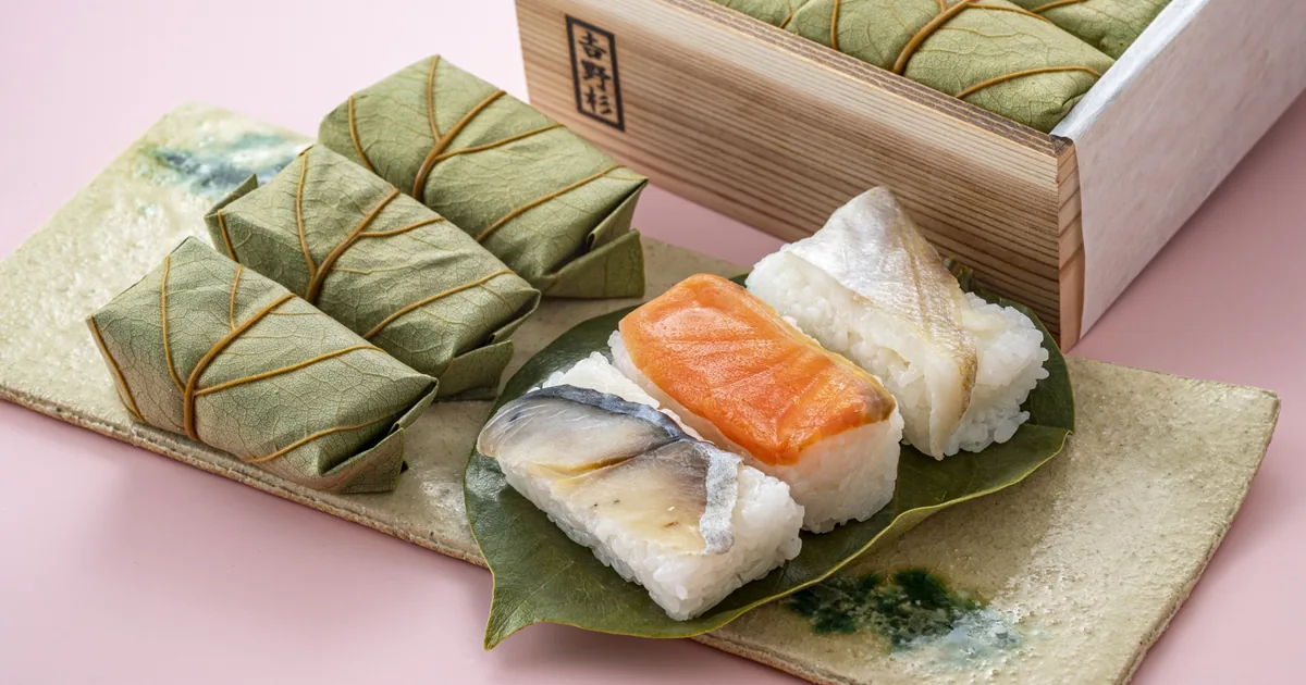 Kakinoha-zushi, Nara persimmon leaf sushi, wrapped in green leaves with three opened to show salted mackerel, salmon and sea bream on vinegared rice